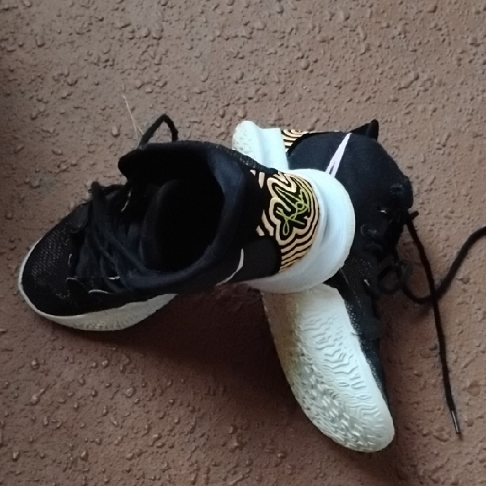 Nike Black Athletic Shoes with White Soles and Subtle Gold Accents